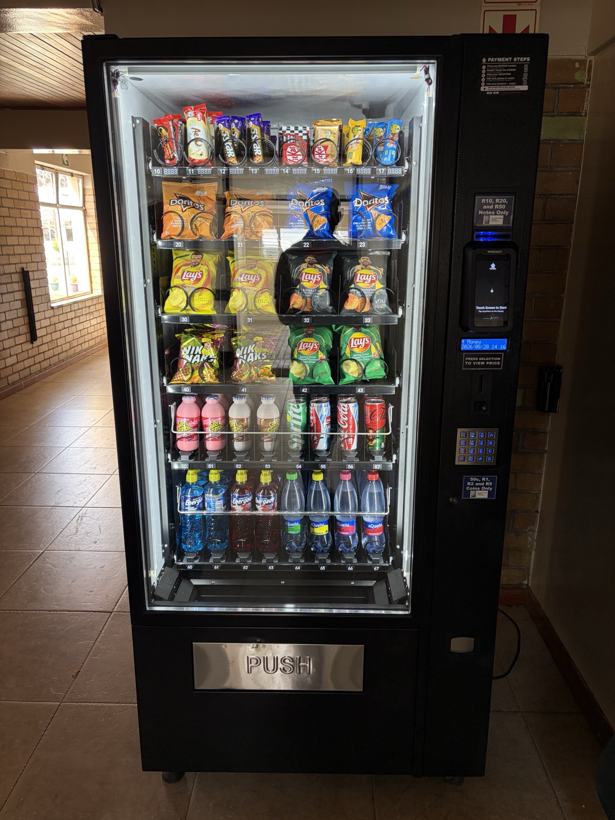 A VendBot payment terminal fitted to a snack and drink vending machine, with cash and card both accepted