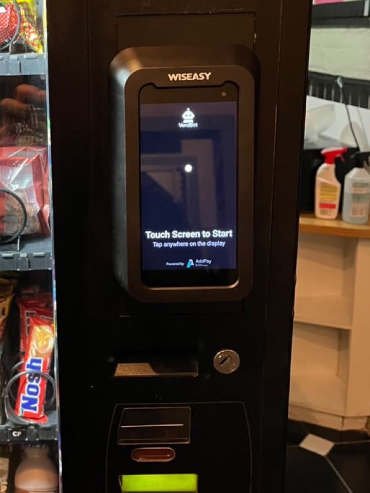 Close-up of the same vending machine's VendBot terminal, ready for a customer to tap