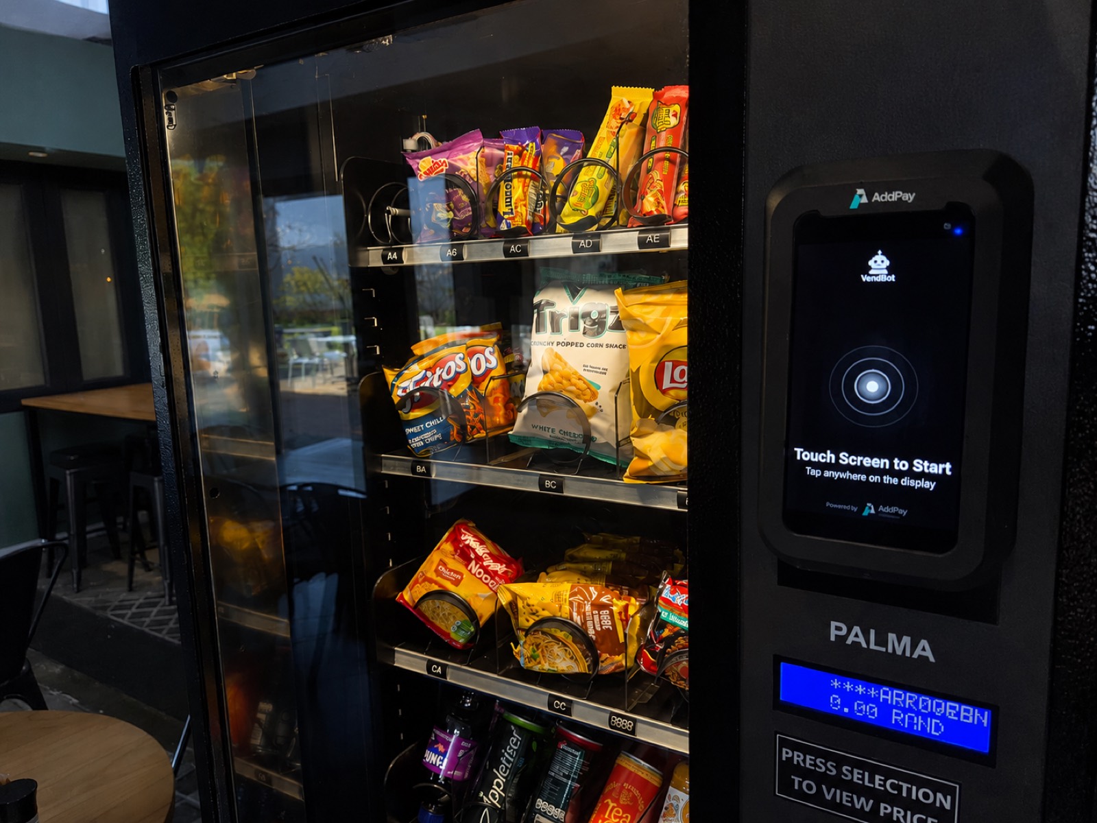 A VendBot P5L payment terminal fitted to the front of a vending machine, ready for a customer to tap